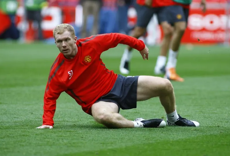 Manchester United's David Beckham, one of the 15 best Premier League midfielders of all time, stretches during a training session.