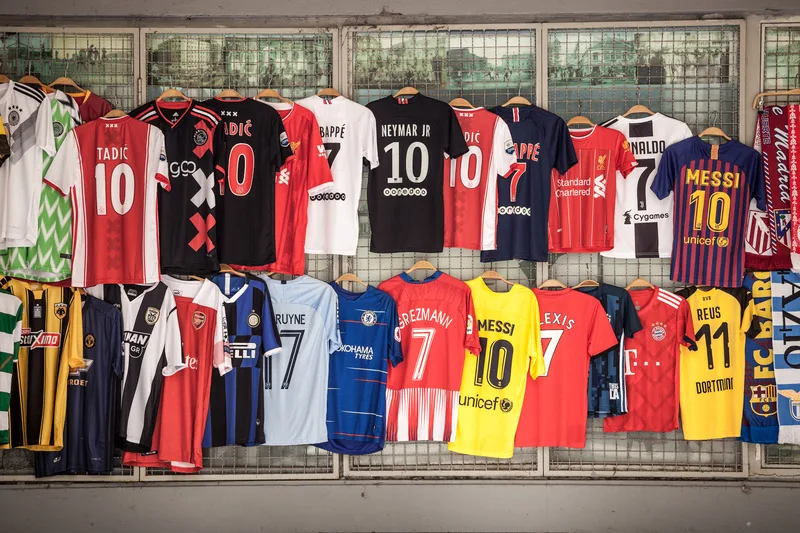 A group of soccer jerseys hanging on a wall, representing the passion and camaraderie of soccer players.