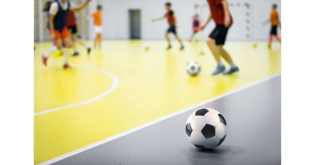 A youth soccer ball on an indoor court.